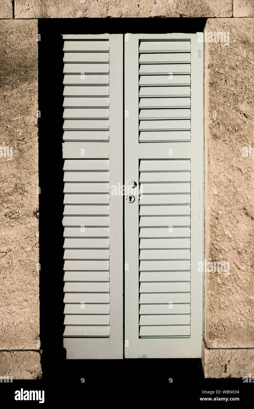 Beach Cabins With Pastel Color Doors Line Up On City Beach Of Hvar