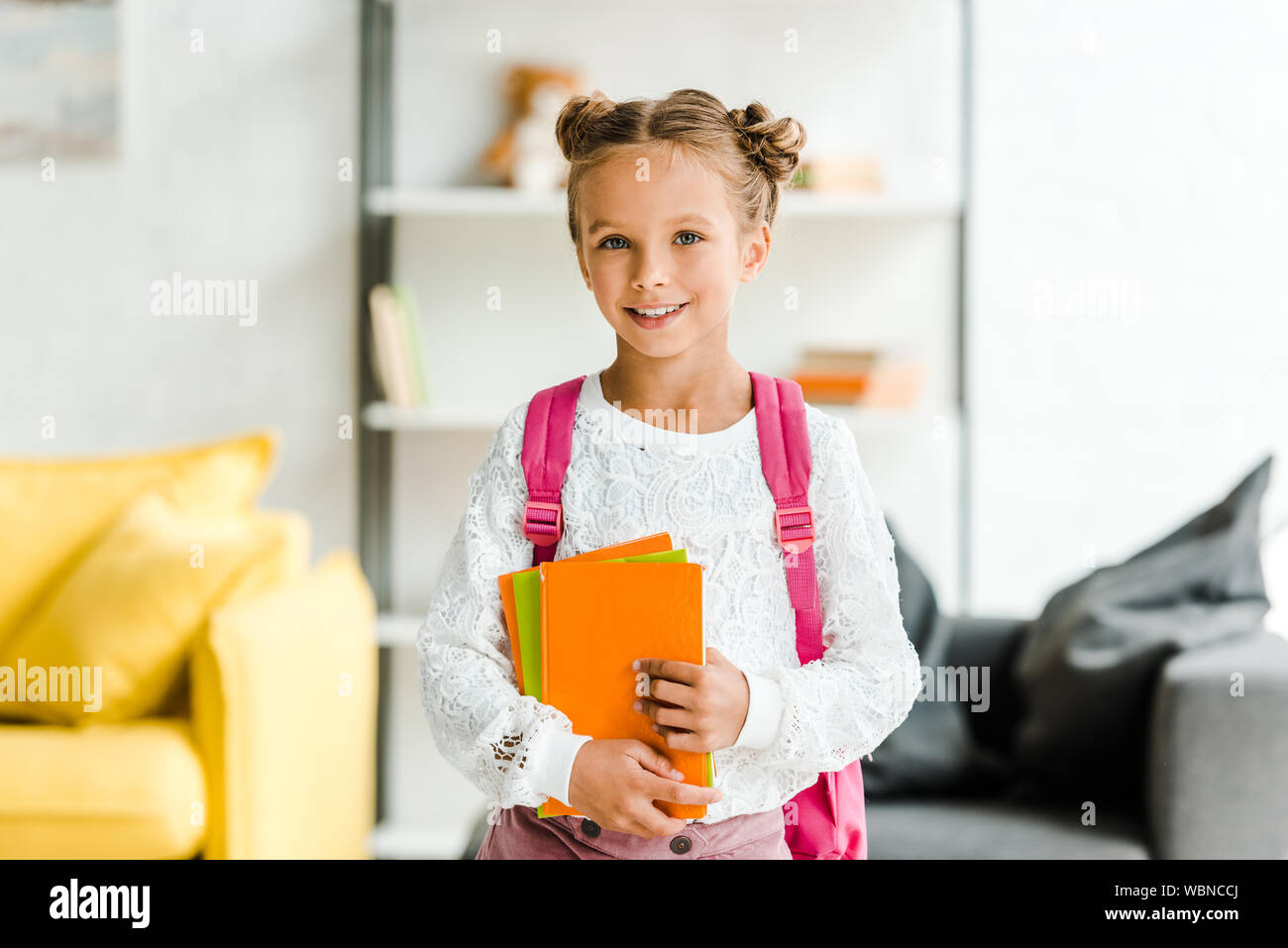 Happy schoolgirl holding books hi-res stock photography and images - Alamy