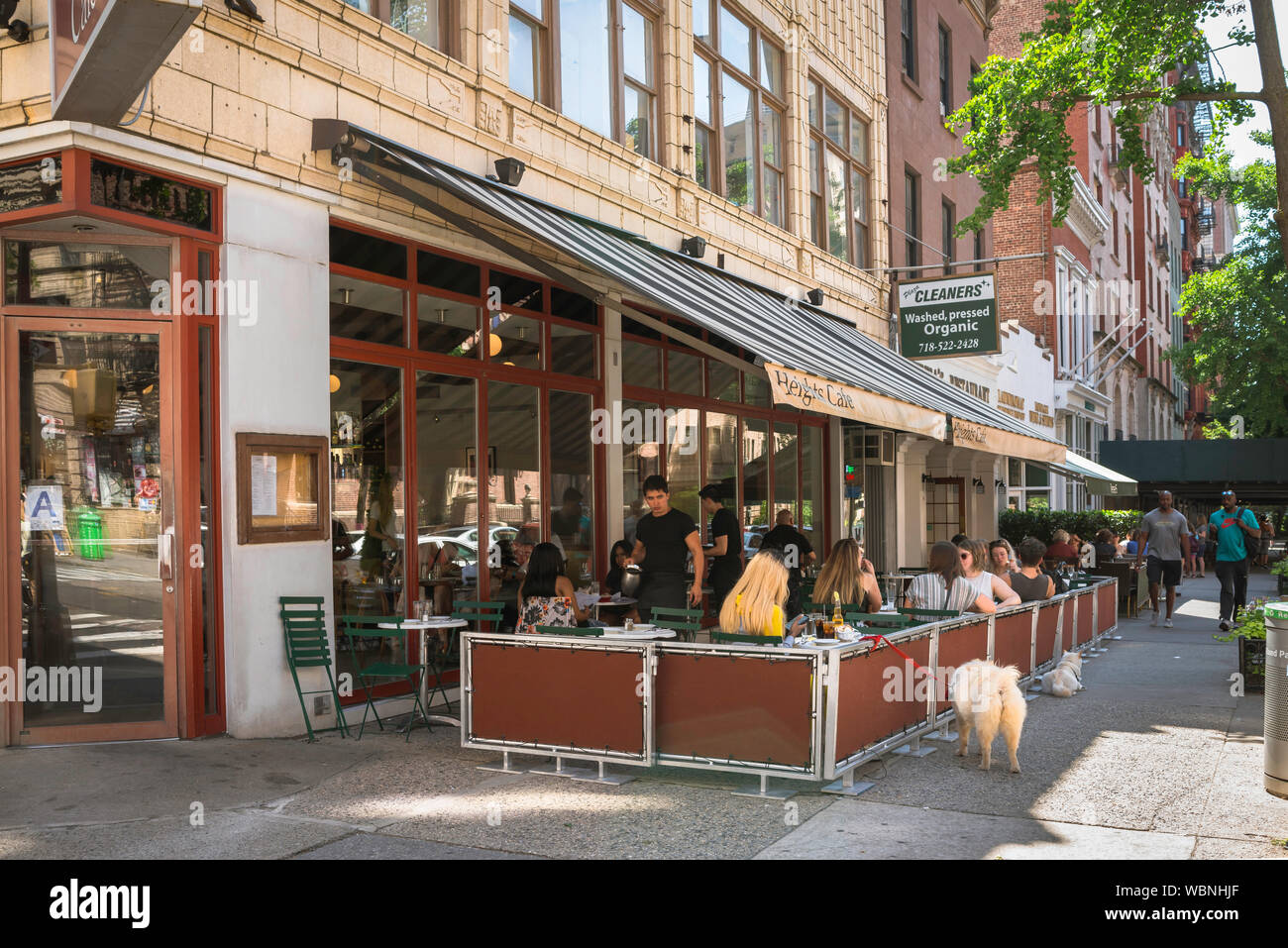Brooklyn cafe, view in summer of people sitting on the sidewalk terrace