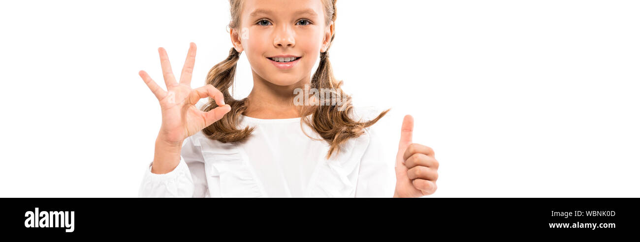 panoramic shot of happy kid showing thumb up and ok sign isolated on ...