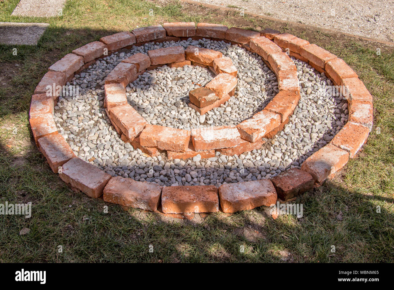 building herbal spiral first layer completed with small pebbles Stock Photo
