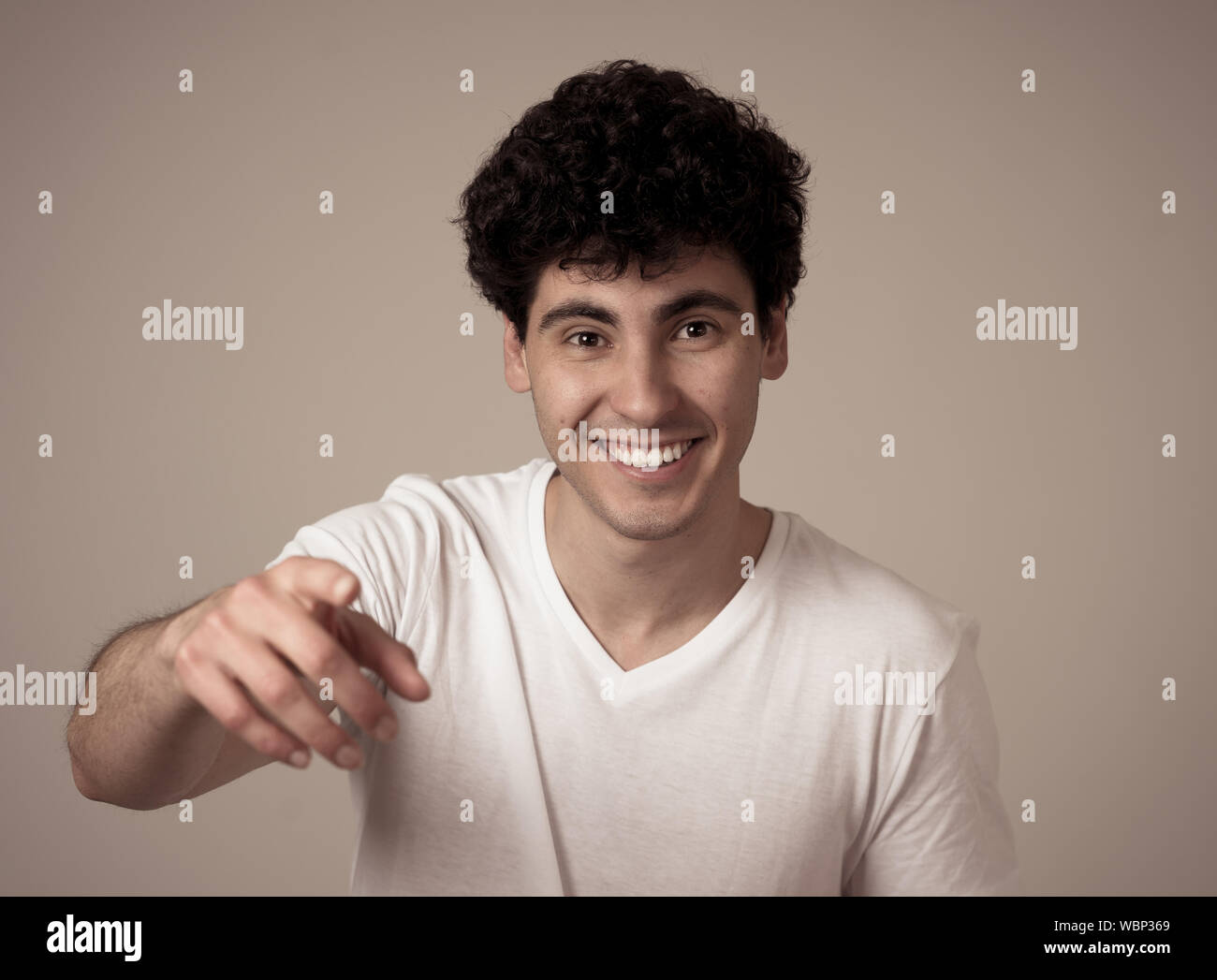 Portrait of Amazed excited funny millennial man pointing at something amazing laughing and making surprise gestures not believing his luck. In Happy f Stock Photo