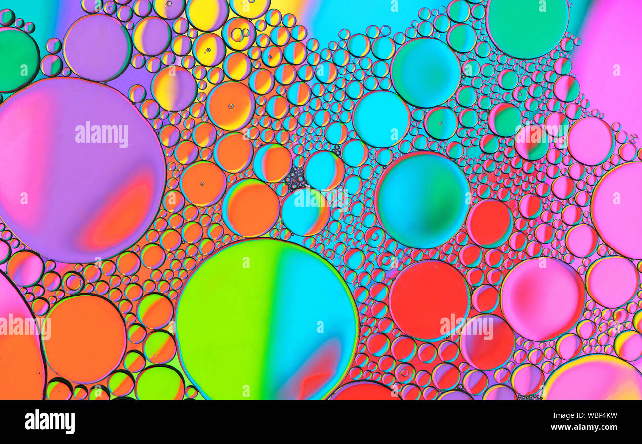 Multicoloured coloured bubble patterns formed by oil floating on water Stock Photo