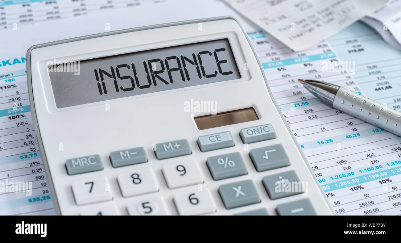 A calculator with the word Insurance on the display Stock Photo