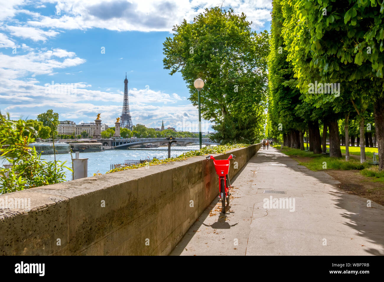 France. Paris. Sunny day. Seine embankment overlooking the Eiffel Tower. Bright red bike Stock Photo