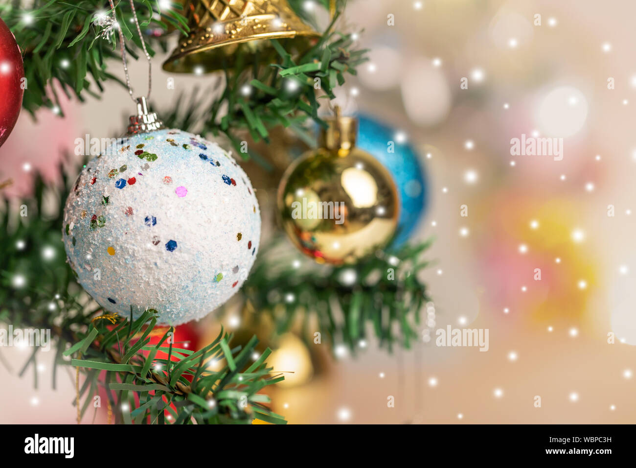 Close Up Christmas Balls And Bell Hanging On The Branch Of The