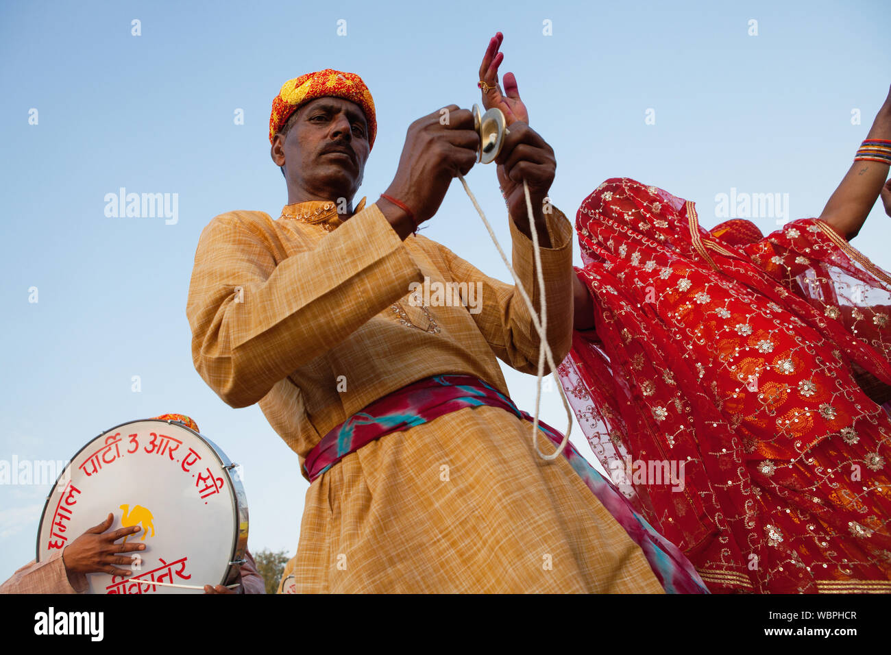 India, Rajasthan, Bikaner, Rajasthani musical troupe and dancers celebrate the festival of Holi. Stock Photo