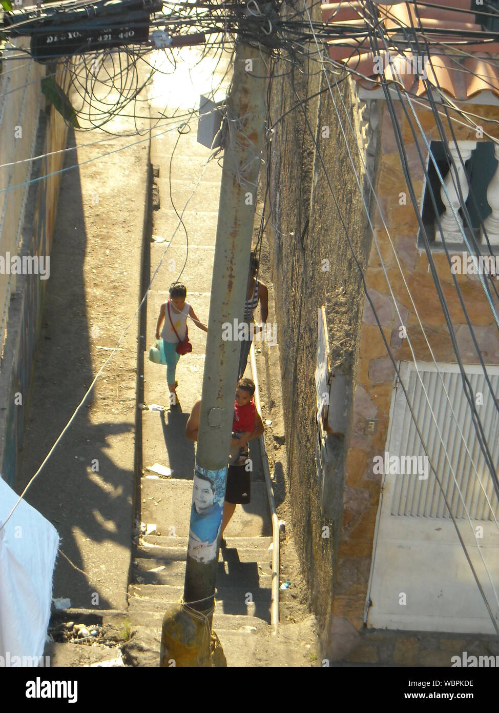 Venezuela, Caracas. Common spaces of the Petare neighborhood where precarious buildings and people doing their daily lives are observed. Stock Photo