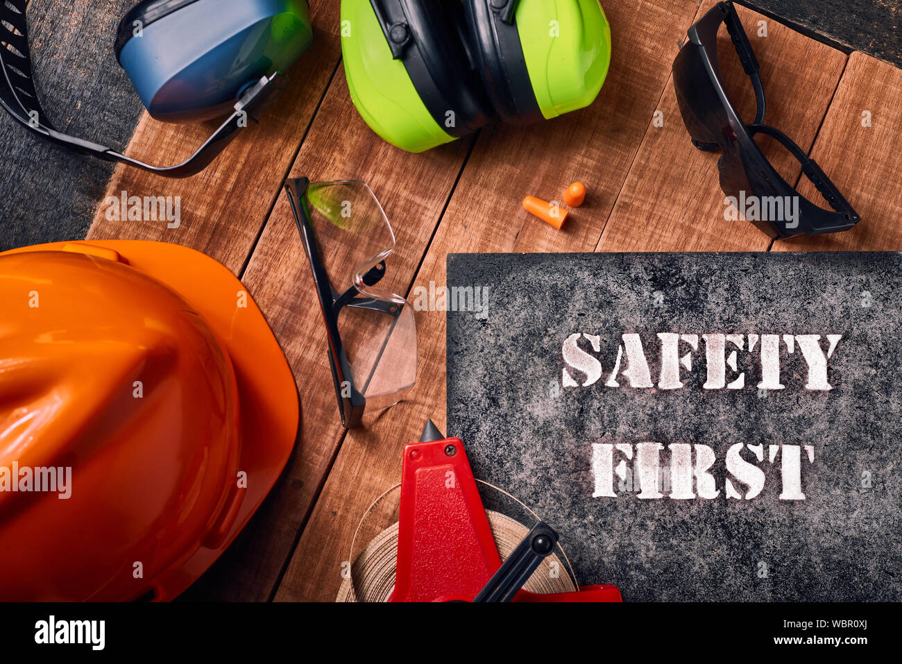 Work safety protection equipment. Industrial protective gear for two on  wooden background. Construction site health and safety concept Stock Photo  - Alamy