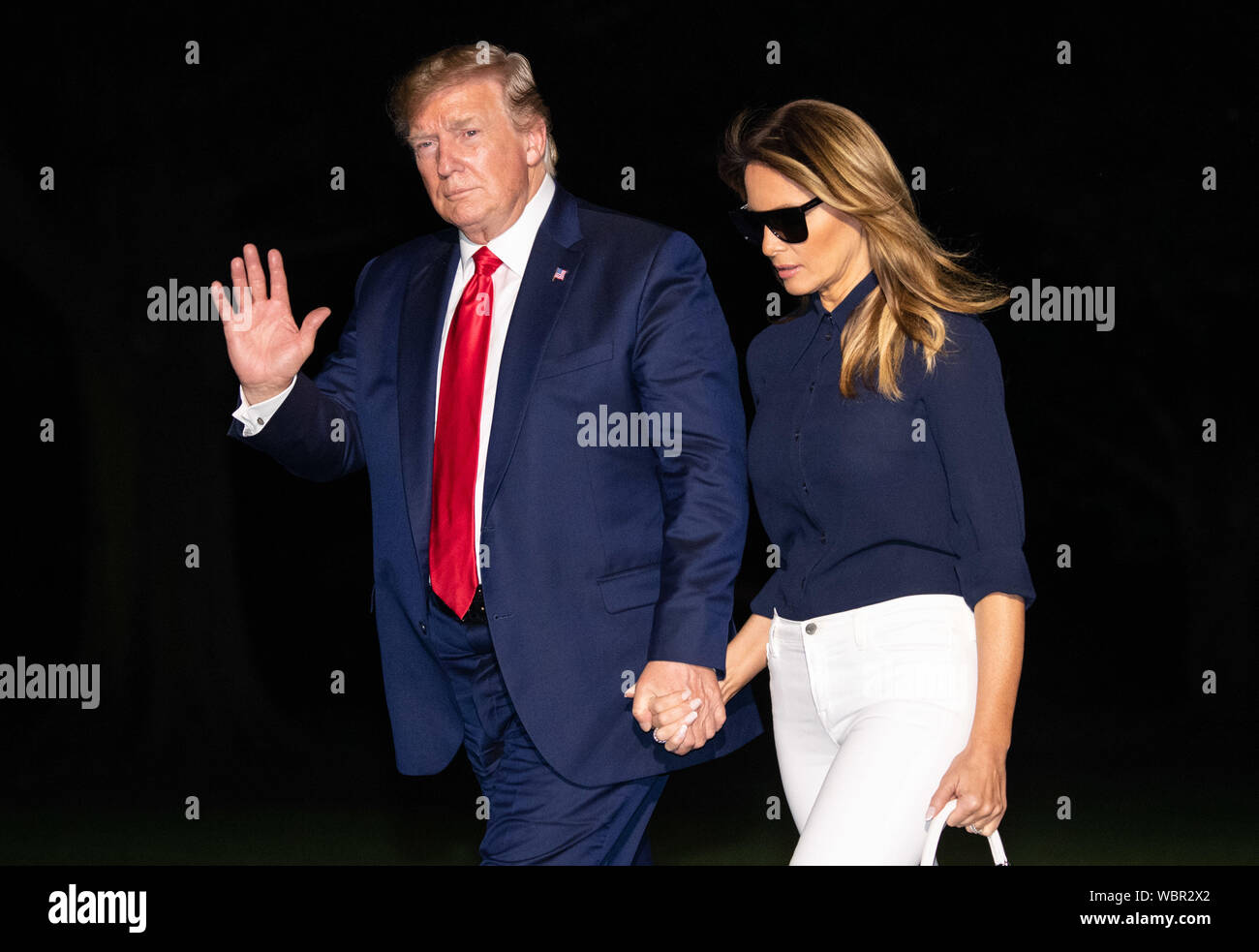 Washington DC, USA. 26th Aug, 2019. United States President DONALD J. TRUMP waves to the press as he and first lady MELANIA TRUMP return to the White House after attending the G7 Summit in France. Credit: Kevin Dietsch/CNP/ZUMA Wire/Alamy Live News Stock Photo