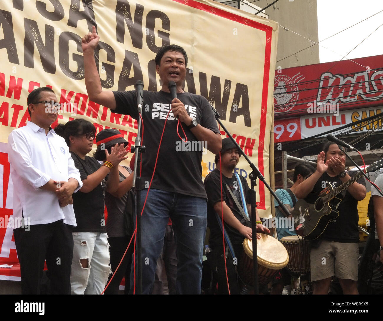 Elmer Labog, United Workers spokesperson speaks to the crowd during the demonstration.Thousands of workers took to the streets as the Philippines marked National Heroes' Day. They call it the 'Martsa ng Manggagawa Laban sa Kontraktwalisasyon' (Workers' March Against Contractualization). They slammed the Duterte Government for allegedly turning a blind eye to the abuses suffered by workers. The United workers calling for an end to 'ENDO' or end of contractualization of workers and the increase of minimum wage of workers to 750 pesos. Stock Photo