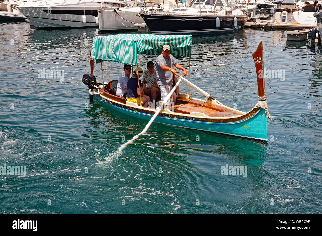 little boat; oars; motor; shade canopy, boatman rowing, people