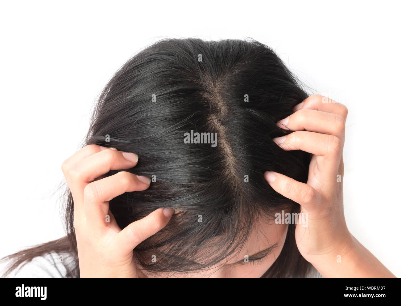 Woman Scratching Head Against White Background Stock Photo