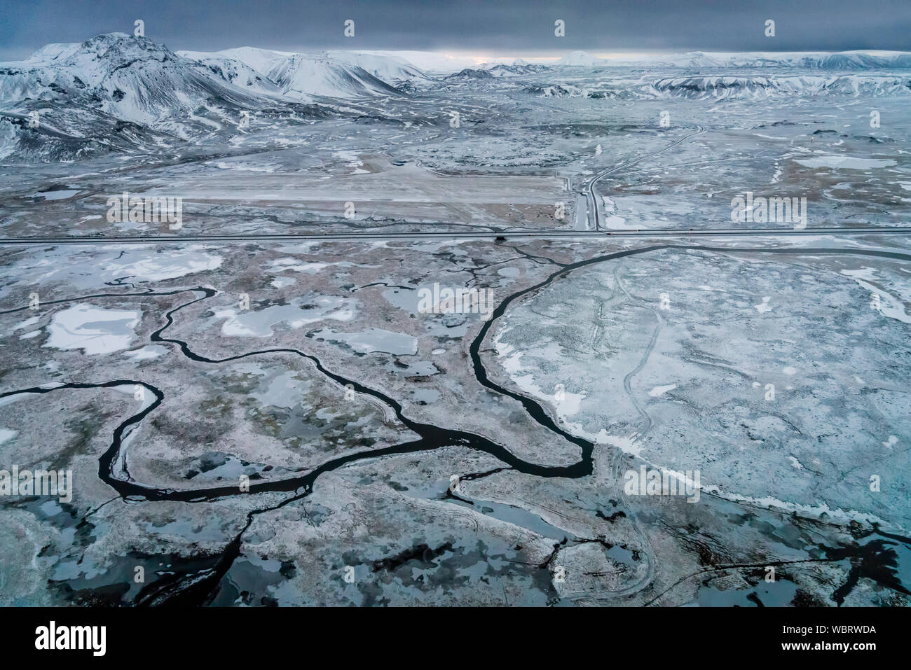 Aerial - rivers, snow and mountains, Hellisheidi, Iceland Stock Photo