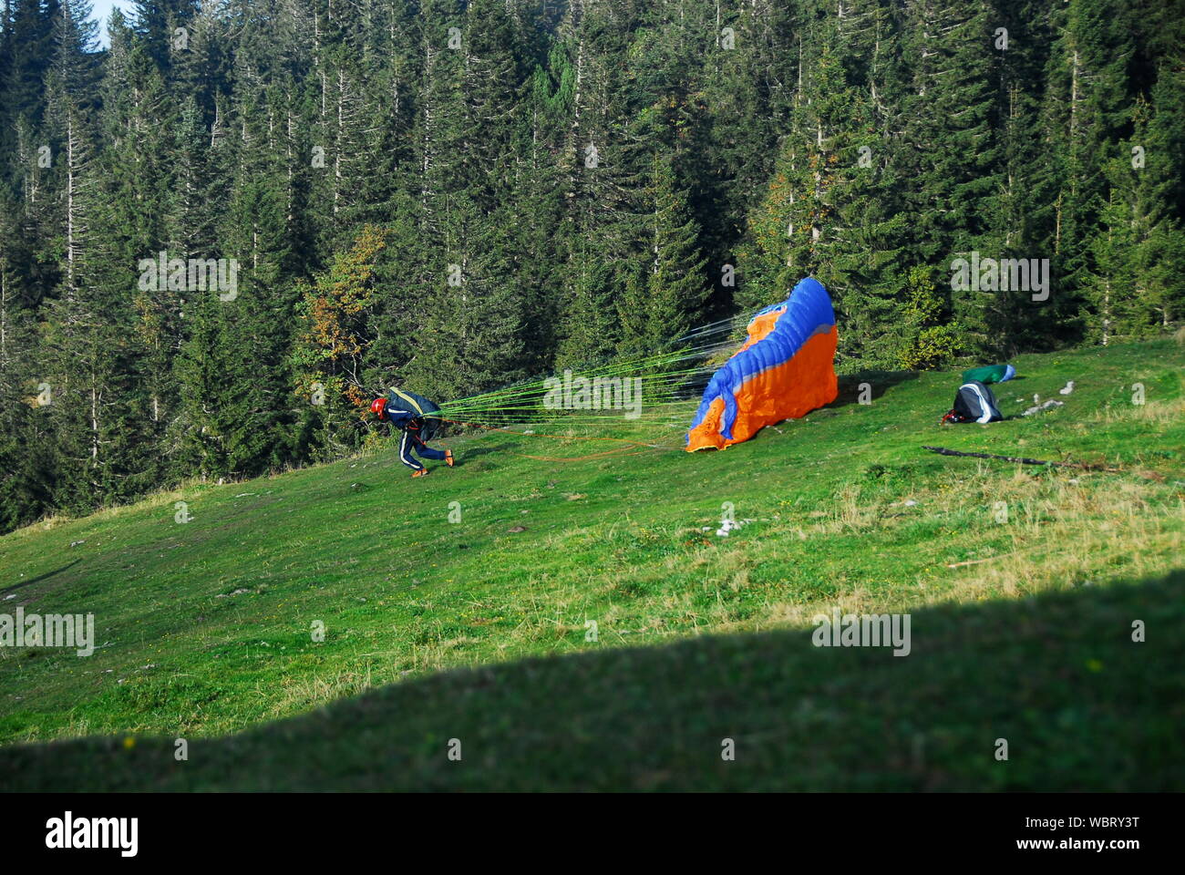 Person Launching Parachute On Field Stock Photo