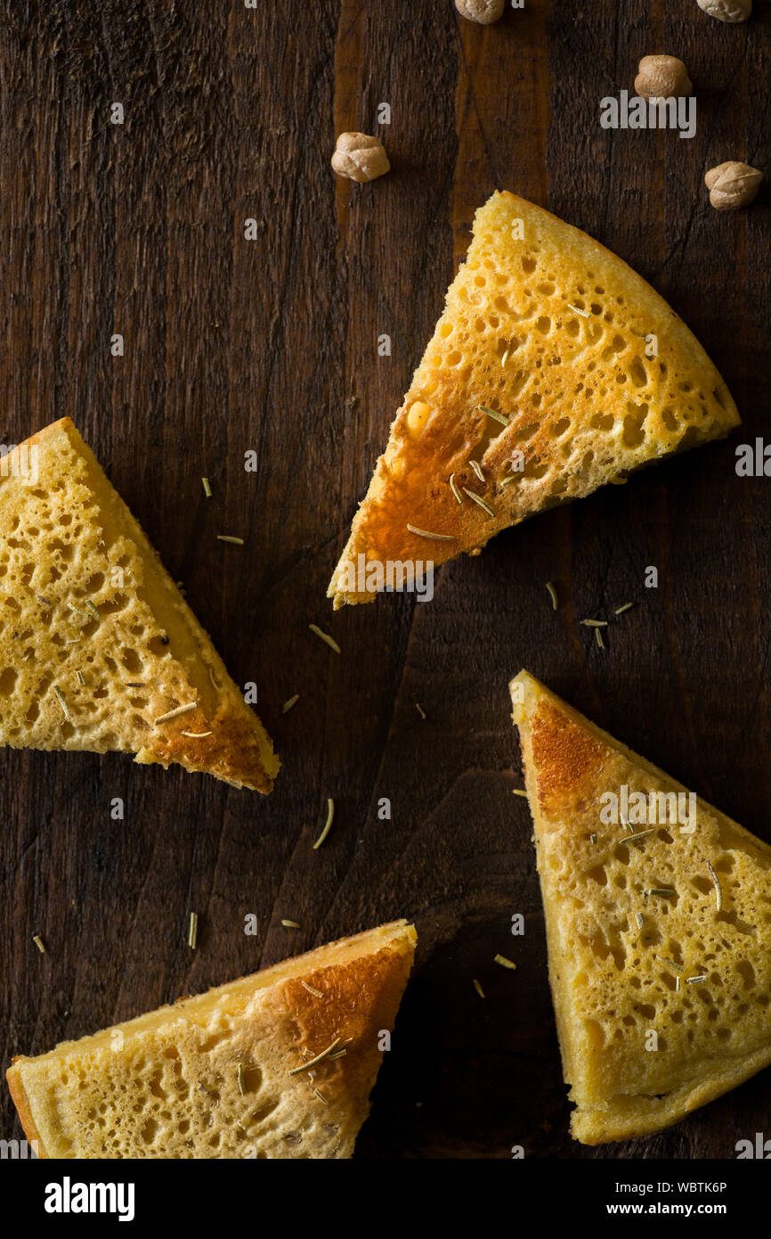 Sliced Chickpea Omelet on Wooden Surface Stock Photo