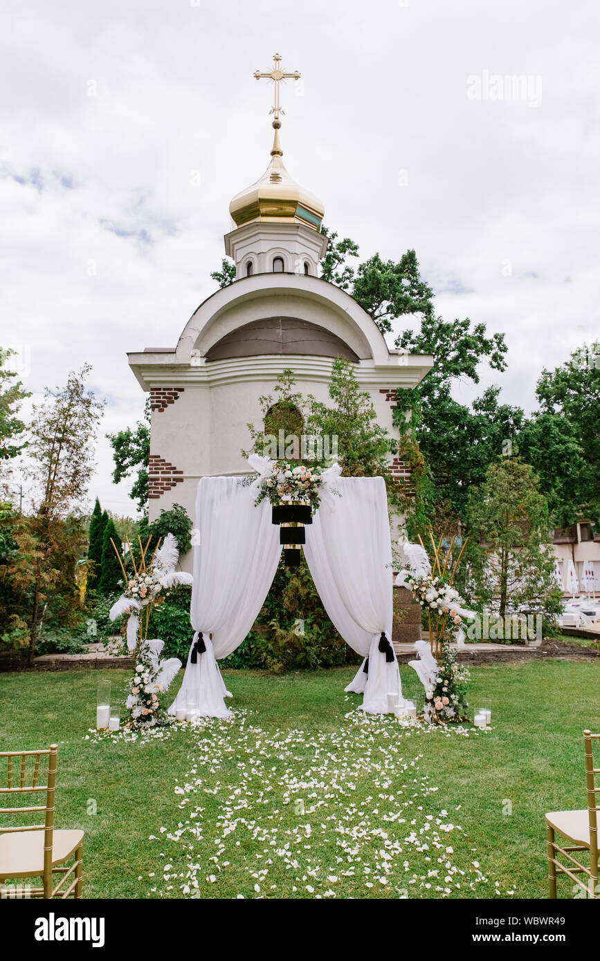 A Very Stylish White Wedding Arch With Unusual Black Decoration