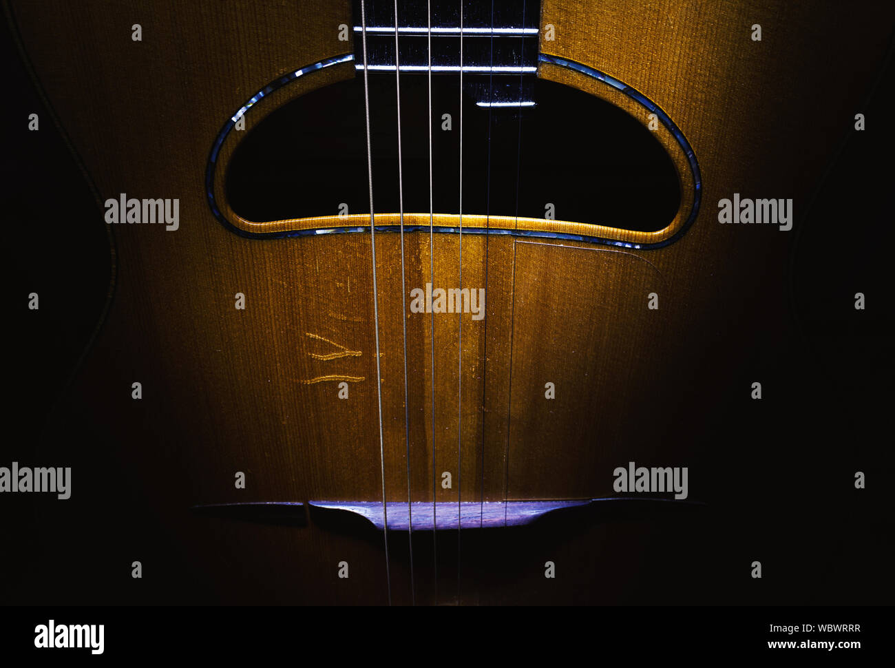 Details of an old and dusty gypsy jazz acoustic guitar, Django style. Stock Photo