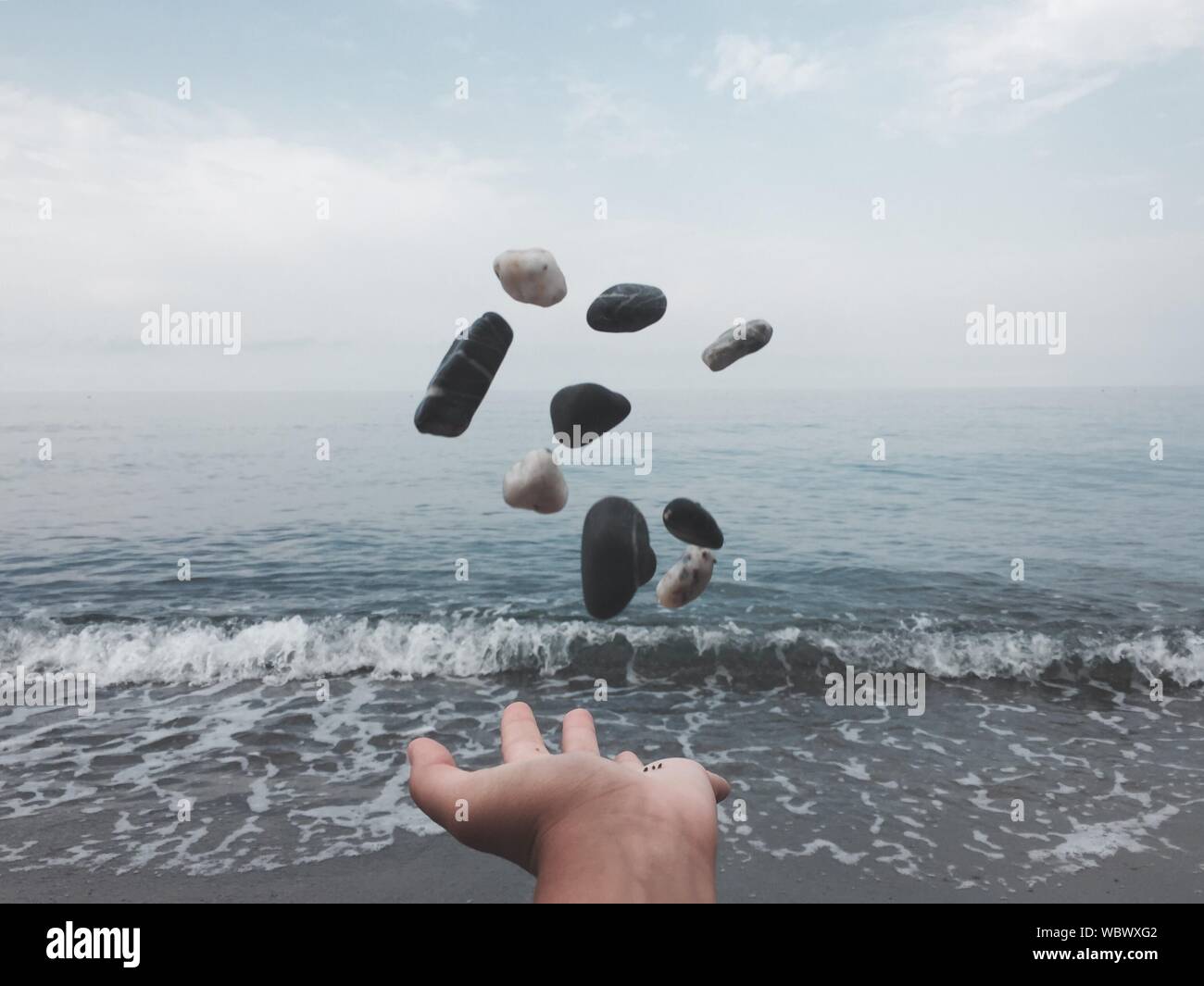 Throwing pebbles into sea hires stock photography and images Alamy