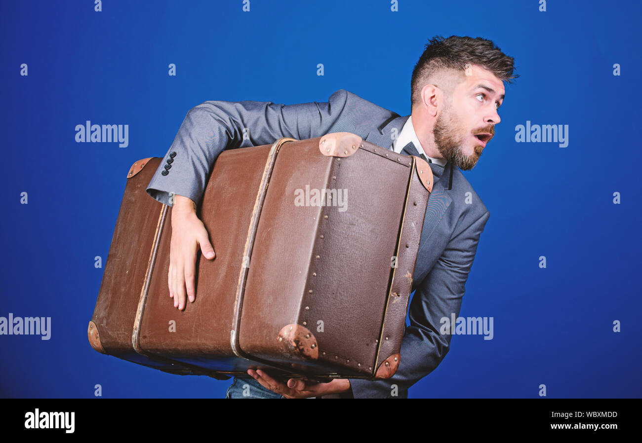 Theft of century. Thief run away with heavy suitcase. Delivery service. Travel and baggage concept. Hipster traveler with baggage. Baggage insurance. Man well groomed bearded hipster big suitcase. Stock Photo