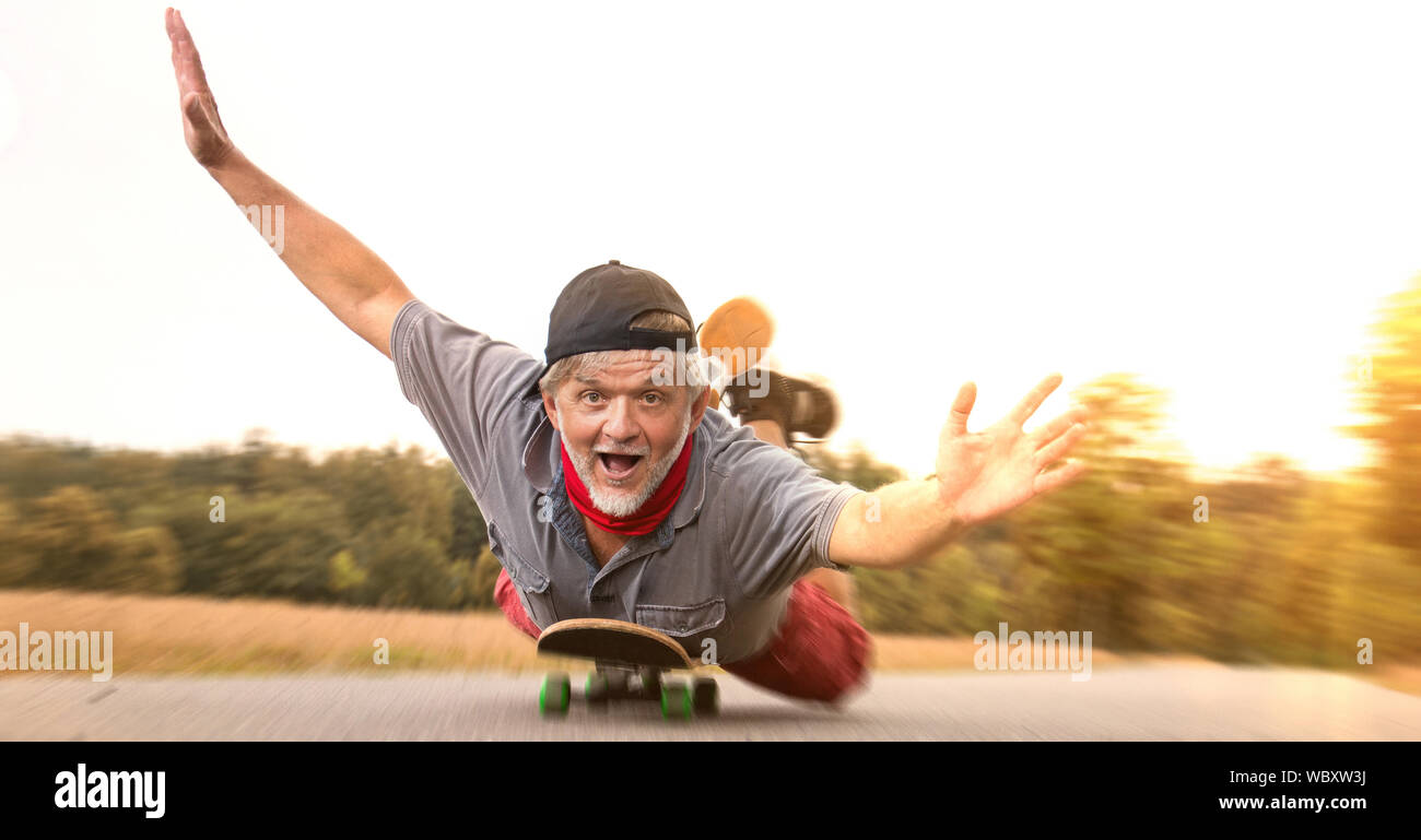 Retiree power on skateboard crazy Stock Photo