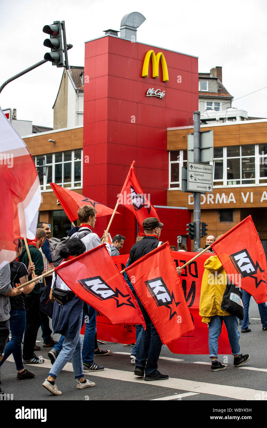 Demonstration of left-wing groups, red flags of communist parties, organizations, McDonalds restaurant, Wuppertal, Germany Stock Photo