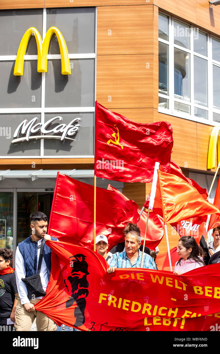 Demonstration of left-wing groups, red flags of communist parties, organizations, McDonalds restaurant, Wuppertal, Germany Stock Photo