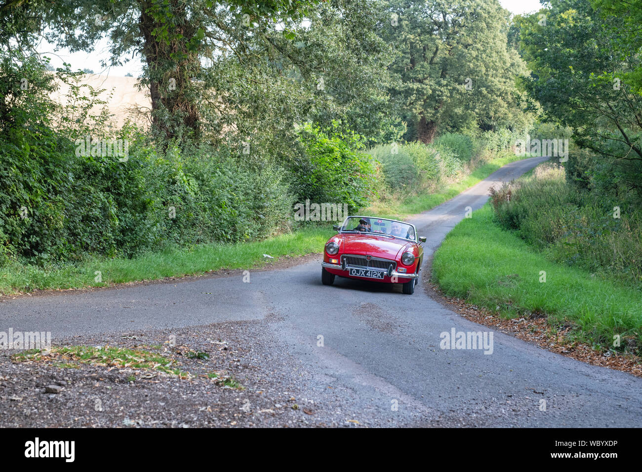1971 MG Roadster  going to a classic car show in the Oxfordshire countryside. Broughton, Banbury, England Stock Photo