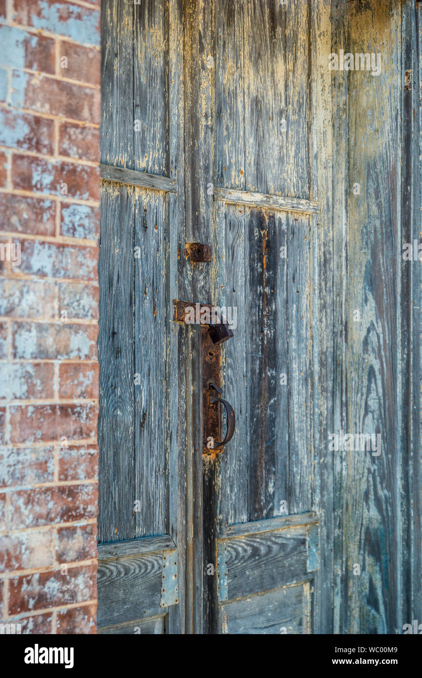 Old Lock And A Rusty Vintage Door Handle On A Peeling Painted
