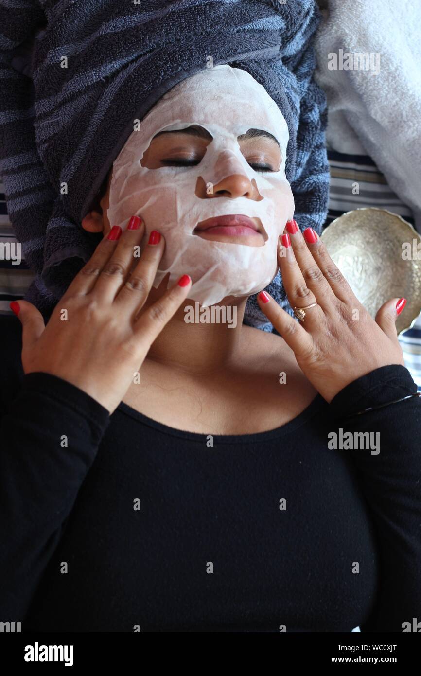 Beautiful woman with facial mask hires stock photography and images