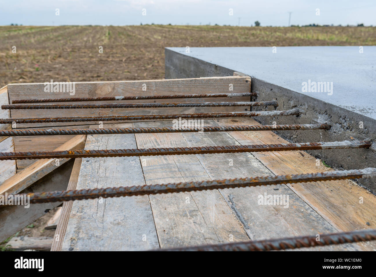 Reinforcing bars sticking out of reinforced concrete slab Stock Photo