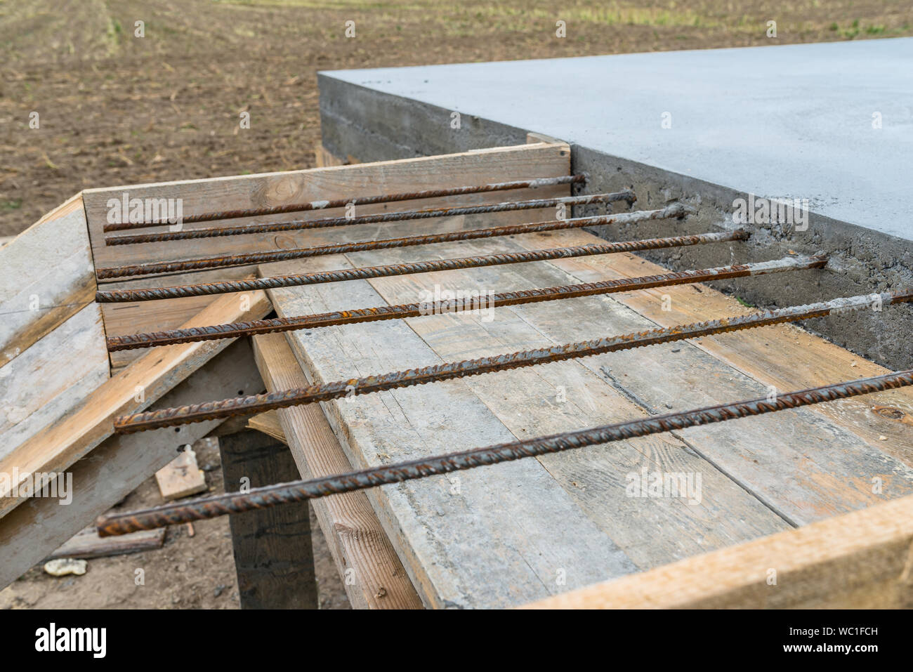 Reinforcing bars sticking out of reinforced concrete slab Stock Photo