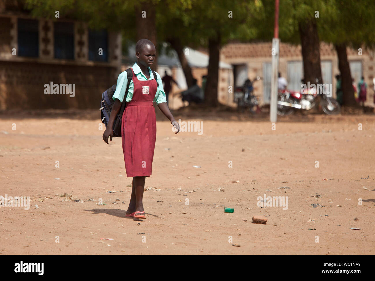 TORIT, SOUTH SUDAN-FEBRUARY 20 2013: Unidentified female student leaves the primary school in Torit, South Sudan Stock Photo