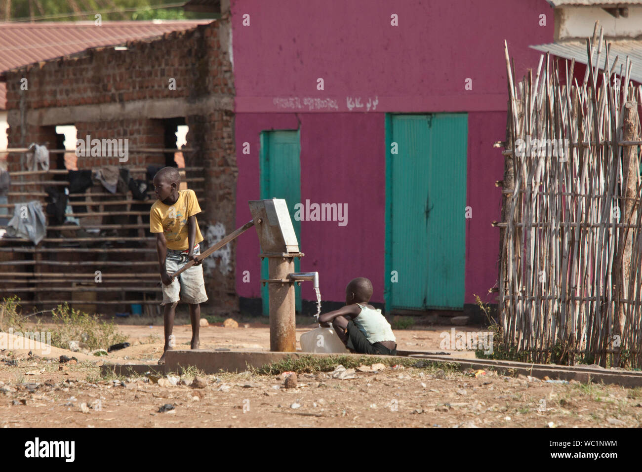 TORIT, SOUTH SUDAN-FEBRUARY 20, 2013: Unidentified children pump water from a well in South Sudan Stock Photo