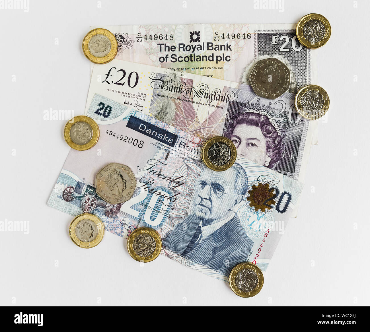 UK currency with Scottish, Irish and English twenty pound notes and coins. Stock Photo
