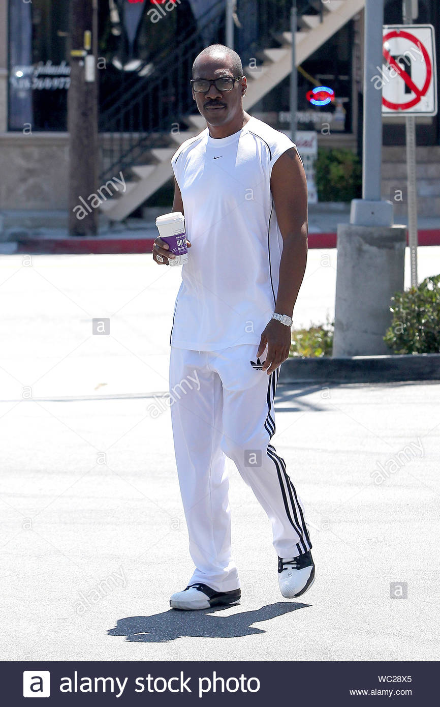 Sherman Oaks, CA - Eddie Murphy gets a little pick-me-up from Coffee Bean  this afternoon, dressed in all white, mixing brands with a Nike shirt and  Adidas track pants. Eddie seemed to