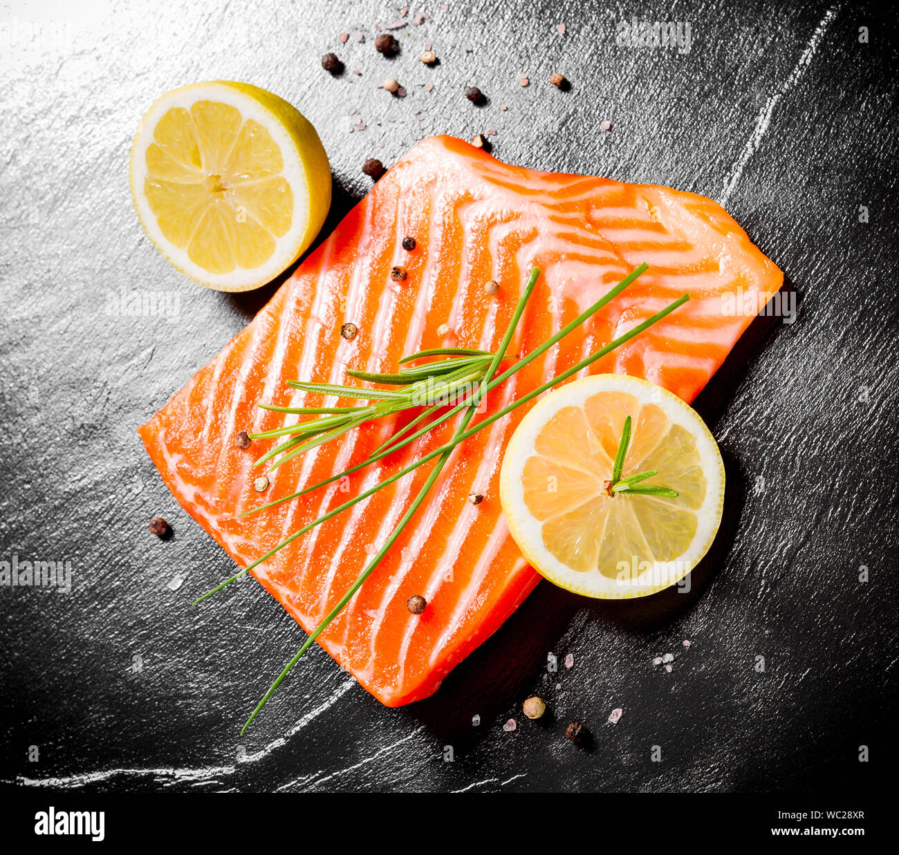 Juicy salmon fillet on black slate plate, top view Stock Photo - Alamy