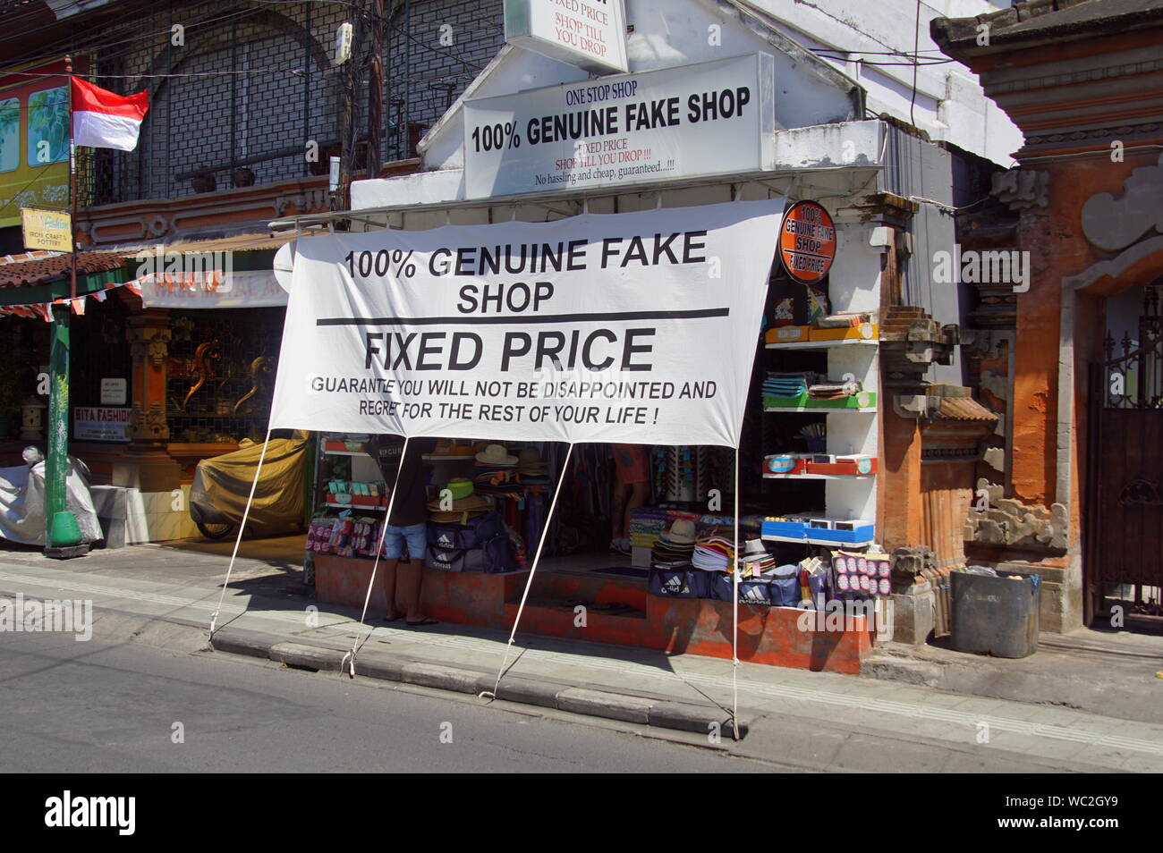 Legian, Bali, Indonesia - August 13, 2018: Indonesian souvenir shop advertising for real fake products. Stock Photo