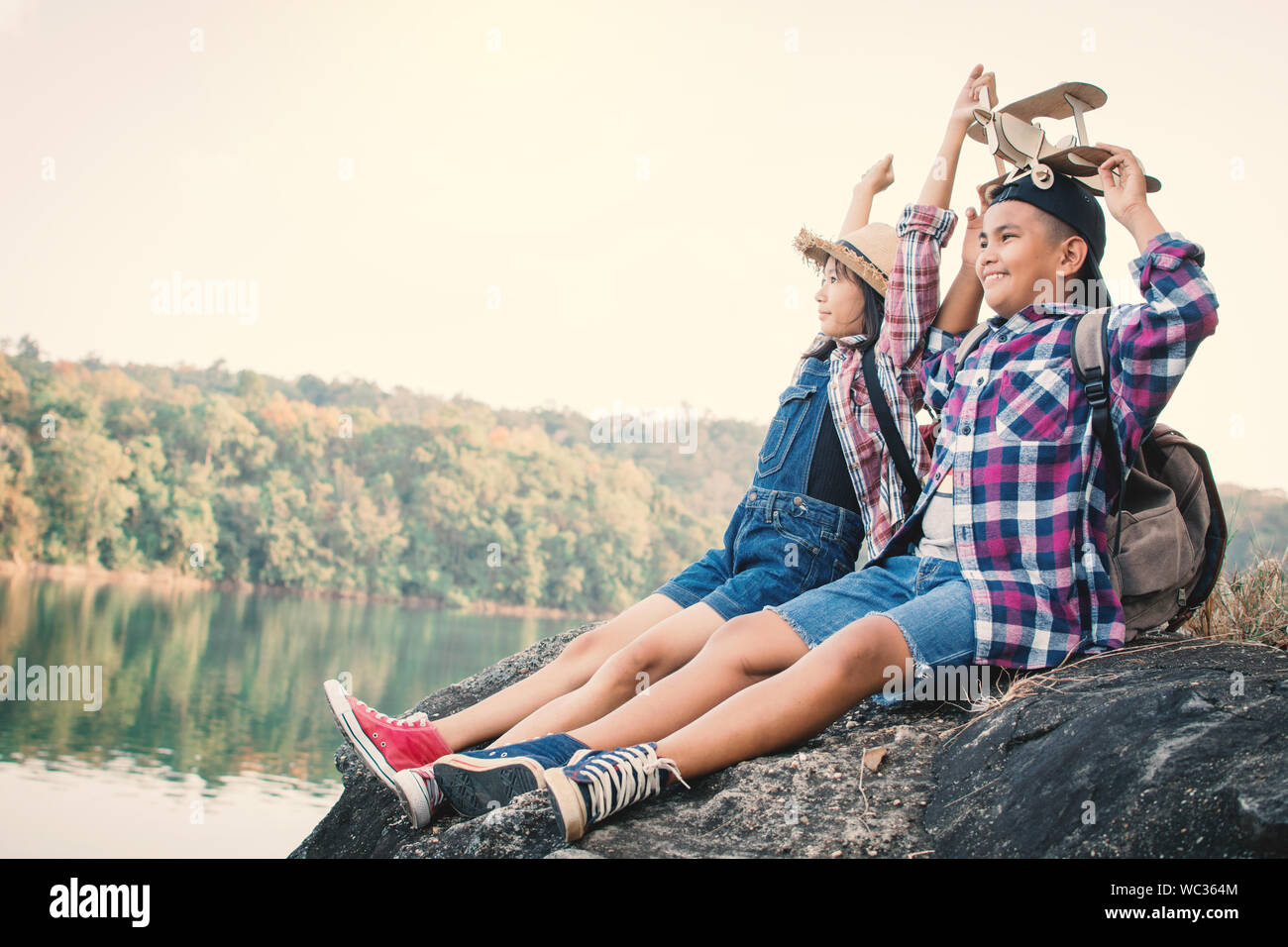 Two boys sitting on rock hi-res stock photography and images - Alamy