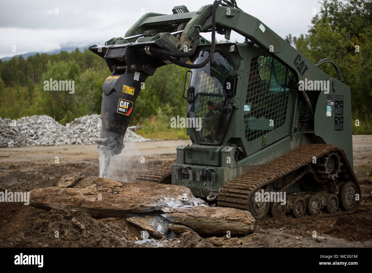A U.S. Marine with II Marine Expeditionary Force, uses a multi terrain loader to break up large rocks during a heavy equipment operation in Setermoen, Norway, Aug. 22, 2019. II MEF Marines conducted operations in support of Marine Rotational Force-Europe 19.2, Marine Forces Europe and Africa, improving ground for artillery units to effectively train in Norway. (U.S. Marine Corps photo by Lance Cpl. Larisa Chavez) Stock Photo