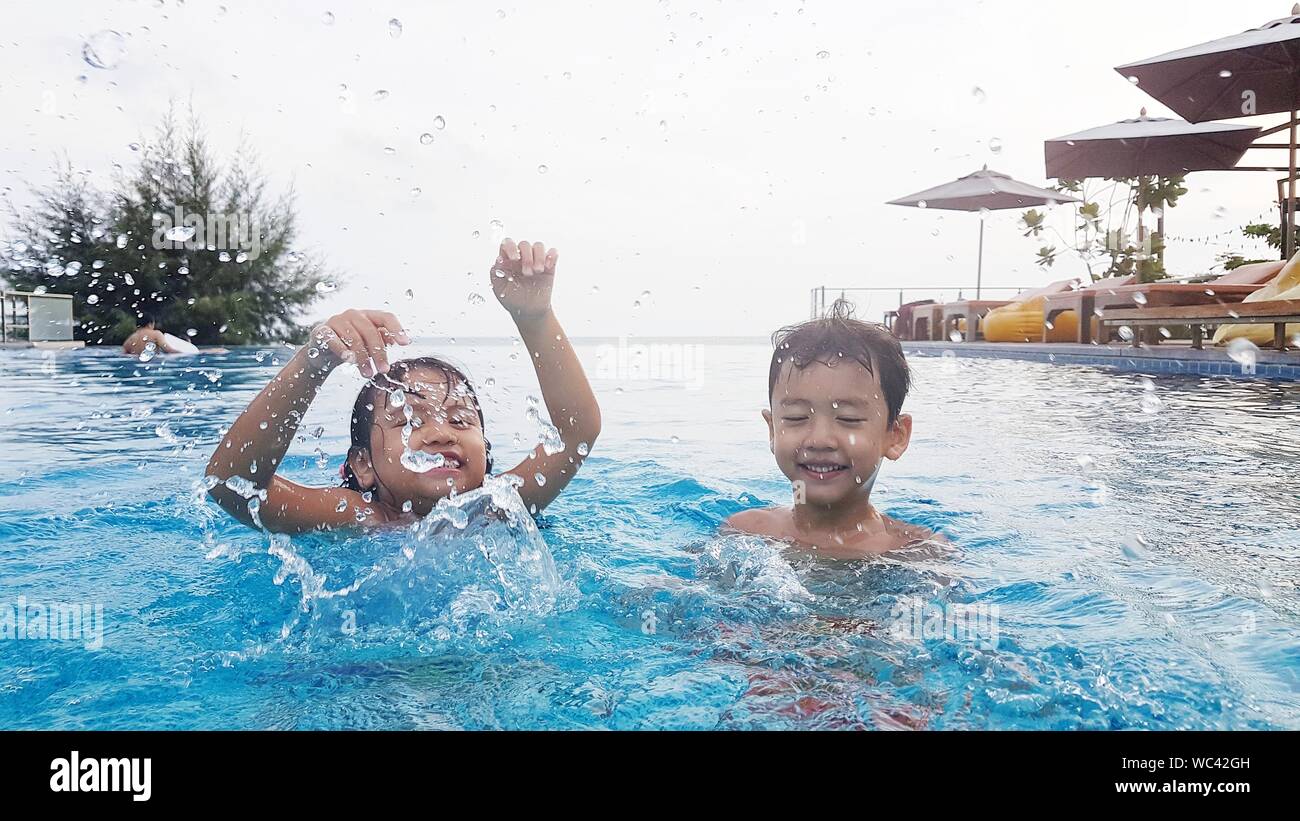 Happy Children In Swimming In Pool Stock Photo