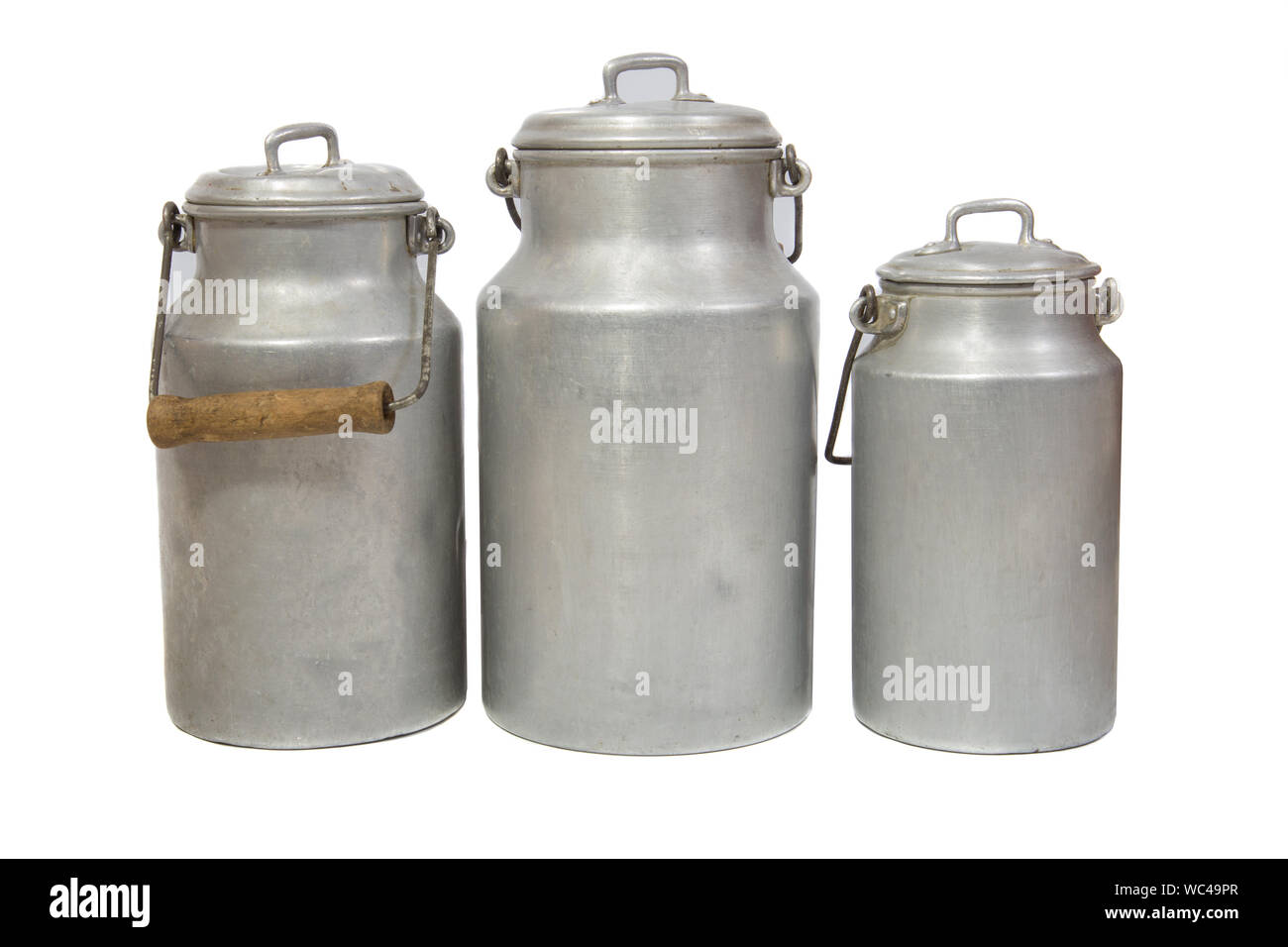 three retro aluminium milk cans on white background Stock Photo