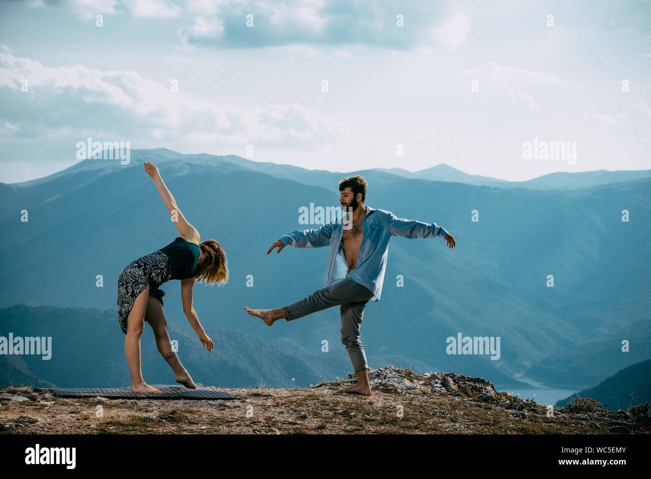 Two athletic young dancers making a performance at mountain peak Stock Photo