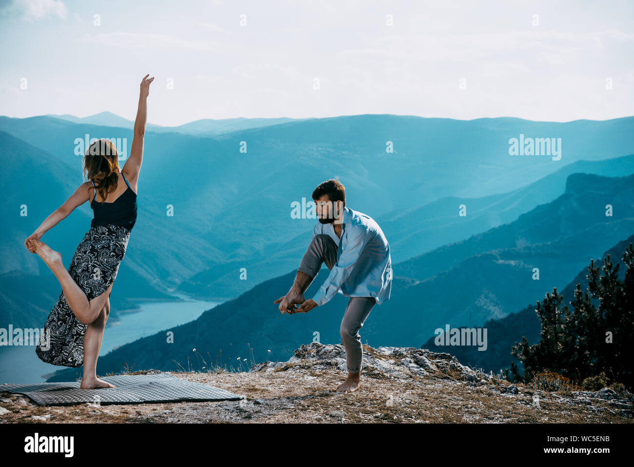 Two athletic young dancers making a performance at mountain peak Stock Photo