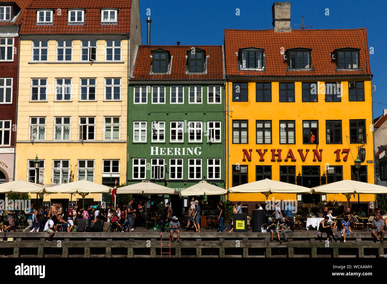 Colorful historical houses in Nyhavn in Copenhagen, Denmark . Nyhavn with  its many restaurants and bars is one of Copenhagen's main tourist  attractions. “Nyhavn” means “New Harbour” , but it is actually