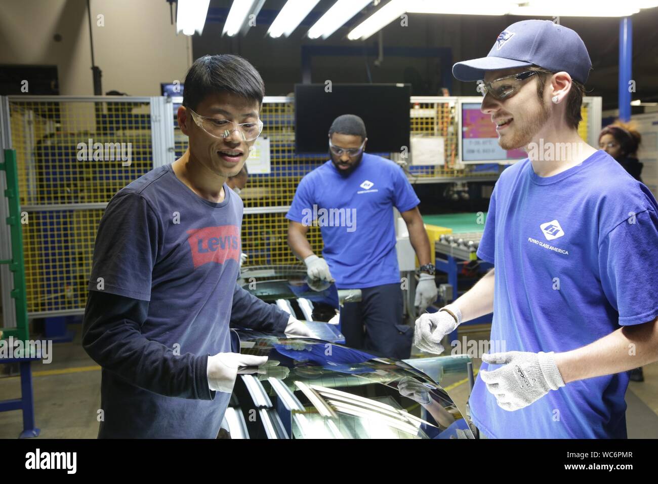 AMERICAN FACTORY, from left Wong He, Kenny Taylor, Jarred Gibson, in the Fuyao factory in