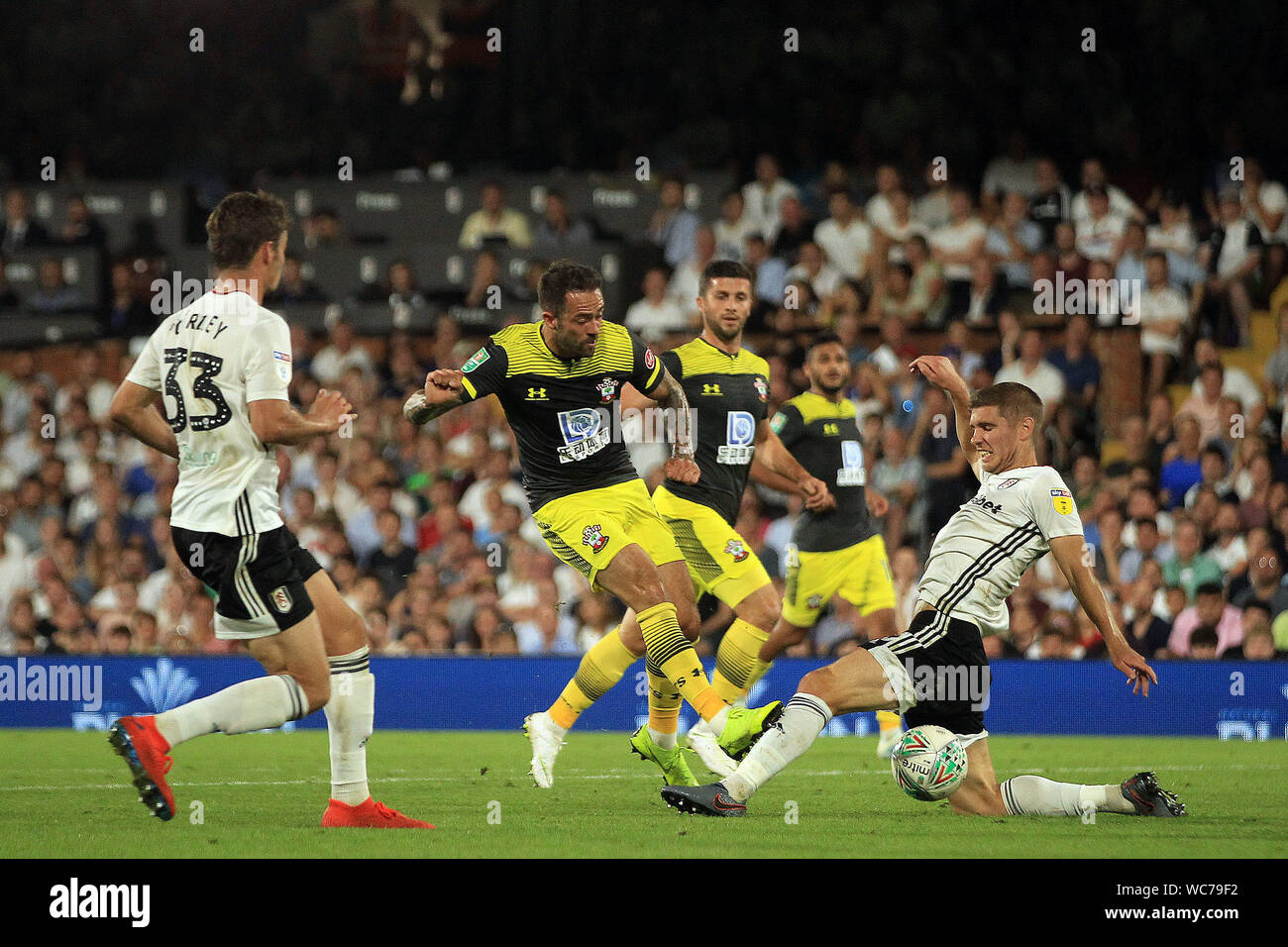 London, UK. 27th Aug, 2019. Danny Ings of Southampton's (M) shot on goal is blocked by Maxime Le Marchand of Fulham (R).Carabao cup 2nd round, EFL cup, Fulham v Southampton at Craven Cottage in London on Tuesday 27th August 2019. this image may only be used for Editorial purposes. Editorial use only, license required for commercial use. No use in betting, games or a single club/league/player publications . pic by Steffan Bowen/Andrew Orchard sports photography/Alamy Live news Credit: Andrew Orchard sports photography/Alamy Live News Stock Photo