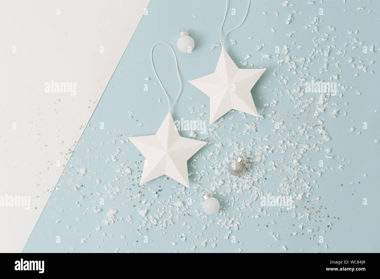 White christmas tree stars and balls sprinkled with snow imitation over blue Stock Photo