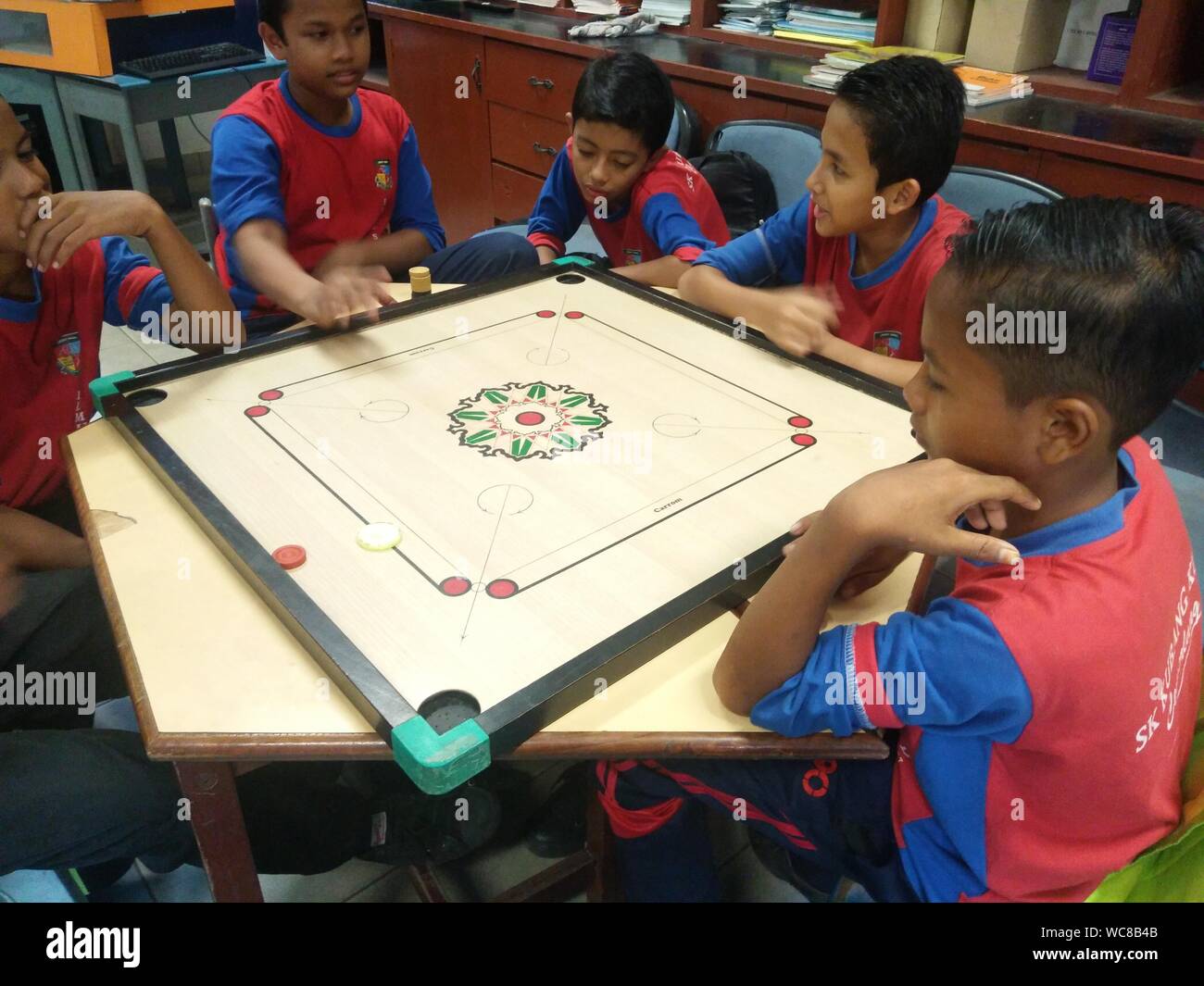 Carrom playing school hires stock photography and images Alamy