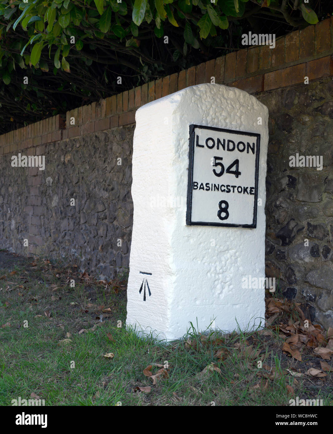 Mile Stone on London Road - B3400 - at Laverstoke, Hampshire, England, UK Stock Photo